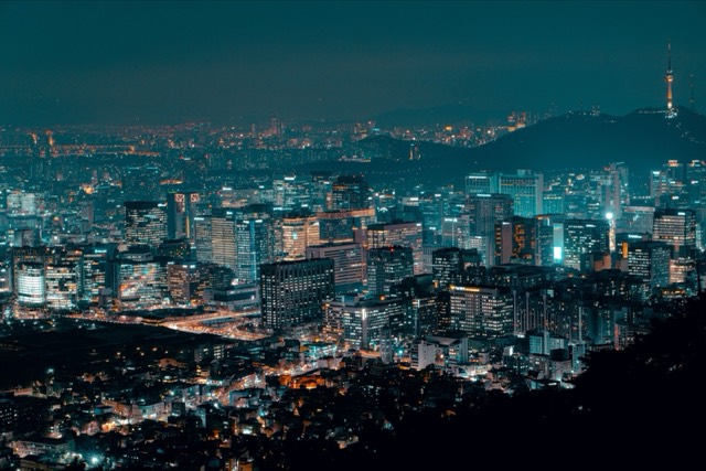 A breathtaking view of a brightly lit city skyline at night, showcasing urban life.
